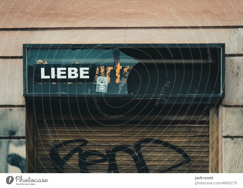 Love is what remains Word Typography German Neutral Background Street art Capital letter Ravages of time Lightbox Roller shutter Store premises lost places