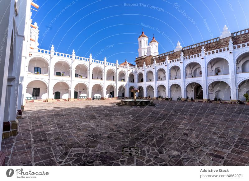 Courtyard of neoclassical style catholic church with arched passage courtyard exterior heritage tourism architecture fountain sightseeing historic