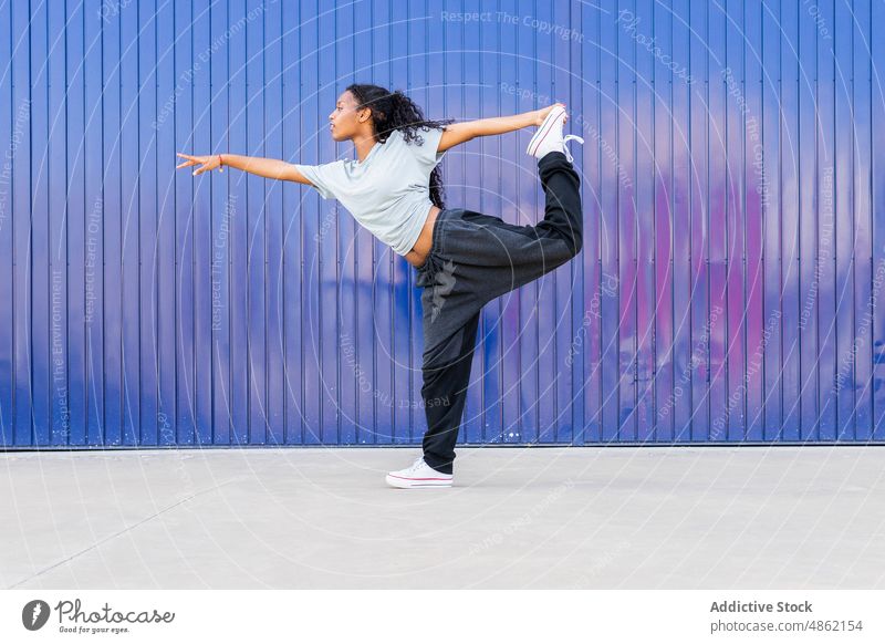 Black woman dancing on street dancer sportive hobby practice exercise rehearsal choreography female energy posture balance flexible healthy lifestyle town