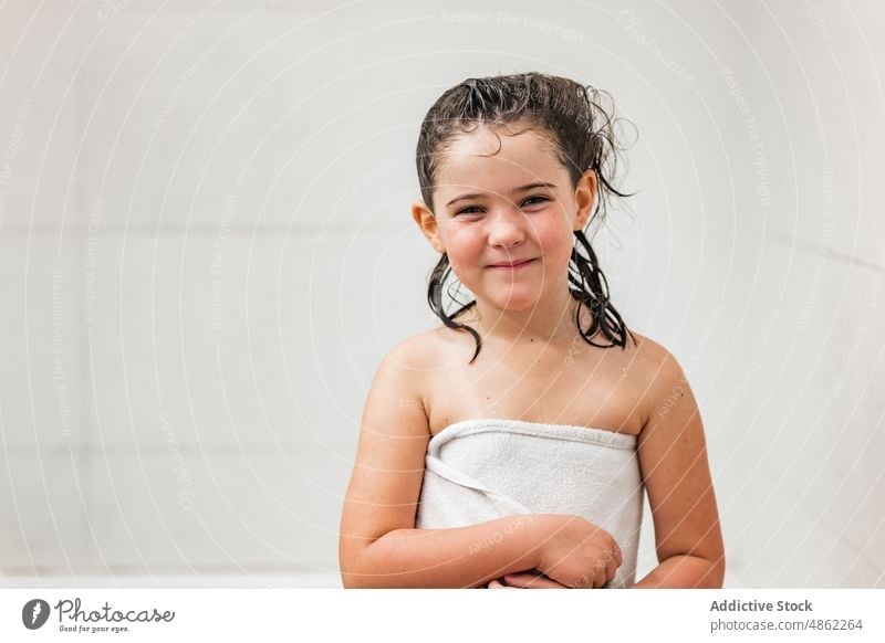 Smiling girl in white towel smile child wet hair bath bathroom portrait preschool kid hygiene routine everyday daily wash shower happy positive cheerful joy