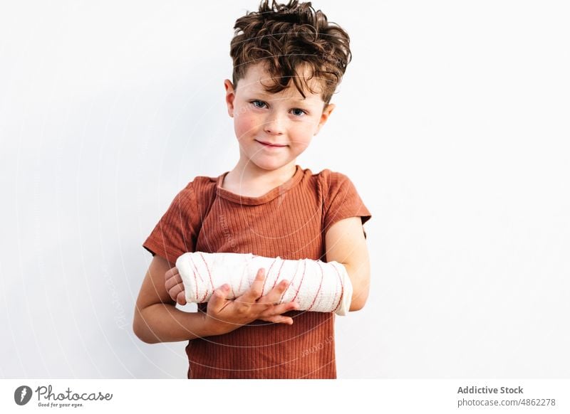 Cute boy with broken arm in plaster bandage smile injury patient pain hurt happy problem childhood kid protect cute adorable trauma medicine little heal
