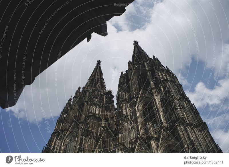 Cologne Cathedral with a modern building, Domforum, old and new architecture travel vacation risky medieval Architecture contrasts spires Church Belief