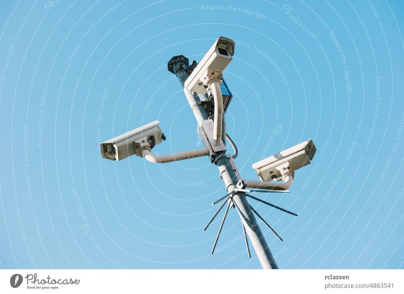 Security cctv surveillance cameras in front of blue sky concept for counter-terrorism, protesters, antiterrorism and protection from crime ccd police safety