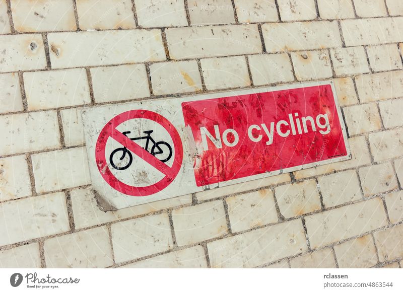 Sign, No Cycling on a dirty brick wall cycle forbidden indicator park prohibit restricted rules safety sign street symbol warning zone bicycle background old
