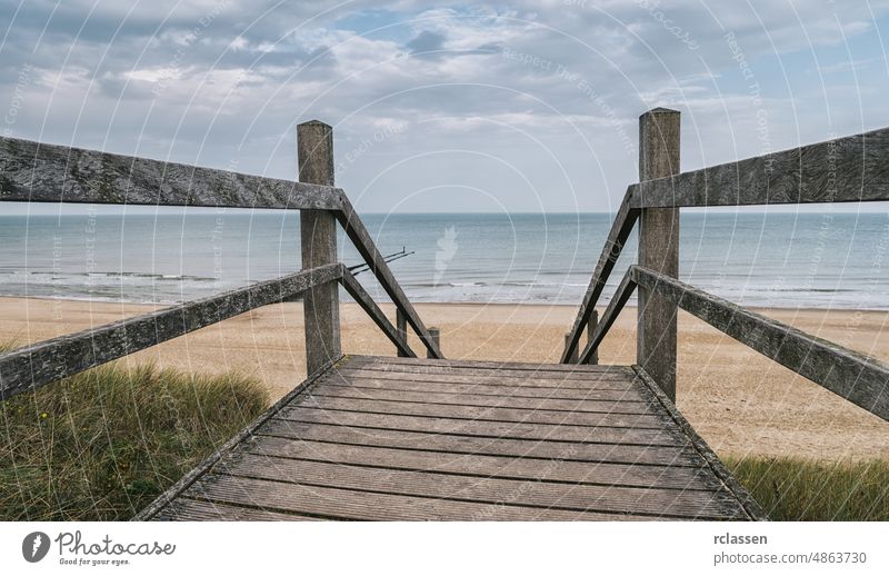 Wooden path at north sea over sand dunes with ocean view on a cloudy day beach walkway access adventure baltic baltic sea boardwalk bridge dramatic sky