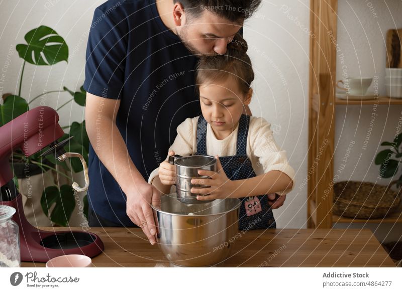 Father And Daughter Sifting Flour Into Mixing Bowl Home Love Kissing Sieve Mixer Dough Table Family Food Ingredient Domestic Lifestyle Together Preparation