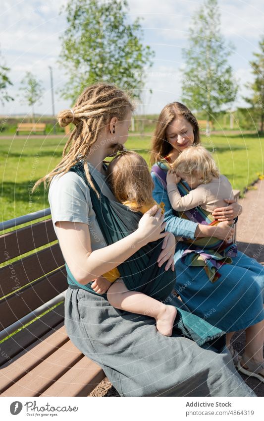 Mothers With Their Babies Sitting On Bench At Park Baby Sunny Friend Sling Together Love Bonding Leisure Lifestyle Smile Happy Relax Rest Mom Beautiful Care