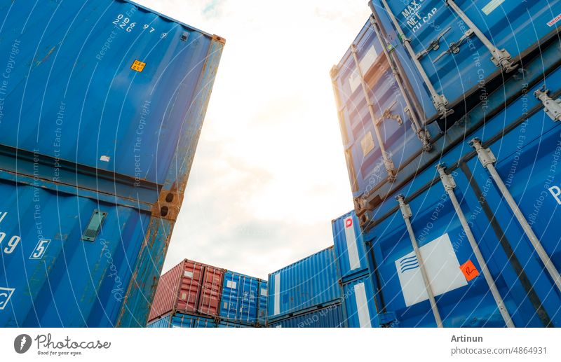 Blue and red logistic container against white sky. Cargo and shipping business. Container ship for import and export logistics. Logistic industry. Container for truck transport and air logistic.