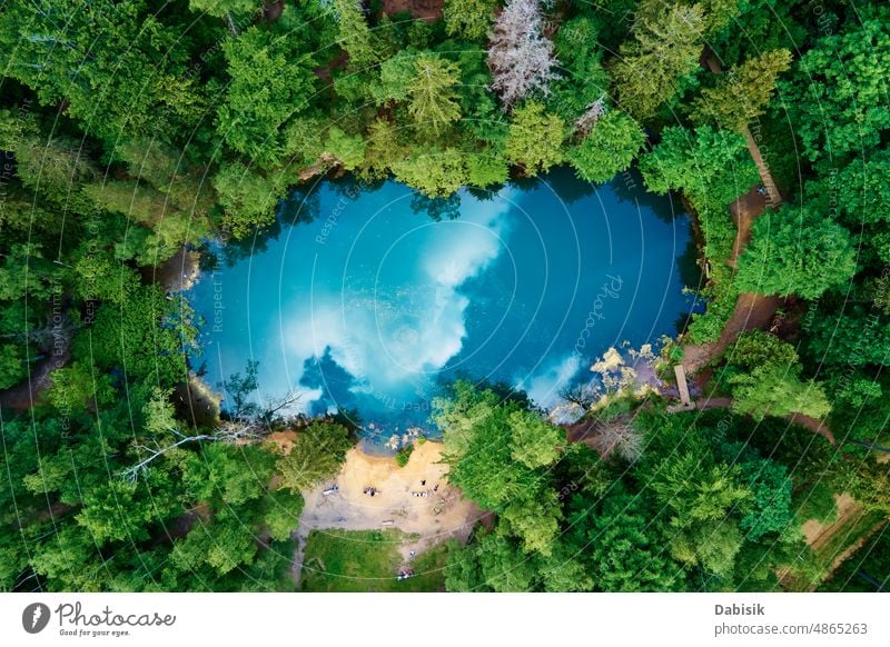 Aerial view of blue colored forest lake in Poland blue lake aerial green pond colorful poland above top water heart wild recreation mountain background