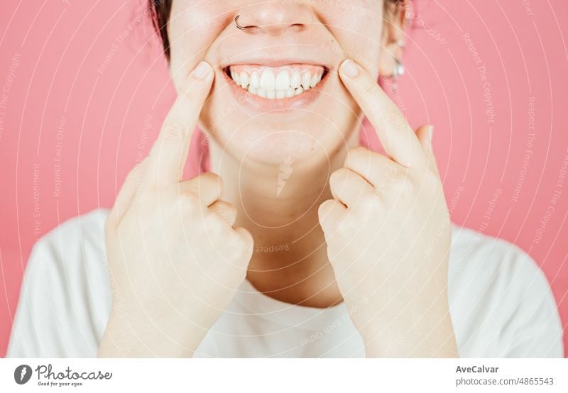 Young woman with big smile smiling to camera with color background and copy space. Happy and fun attitude, mental health and taking care of herself concept. Be happy, smile, white teeth.