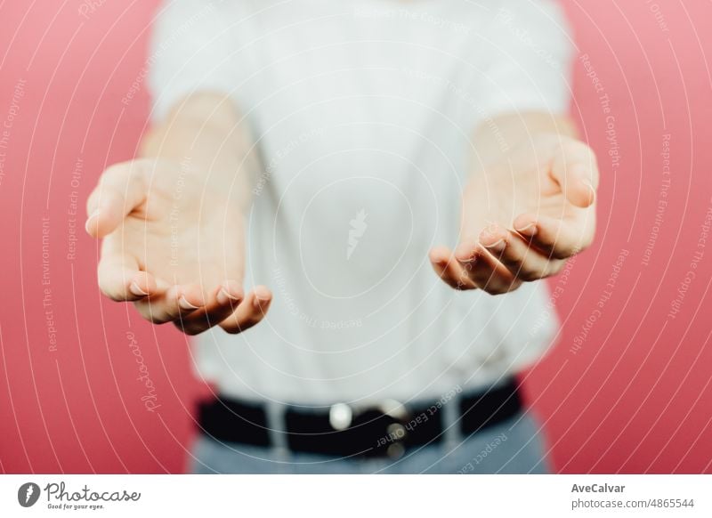 Woman giving hands to the camera over a pink background, help and self help concept, mental health expression gesture signs teenage person care face redhead