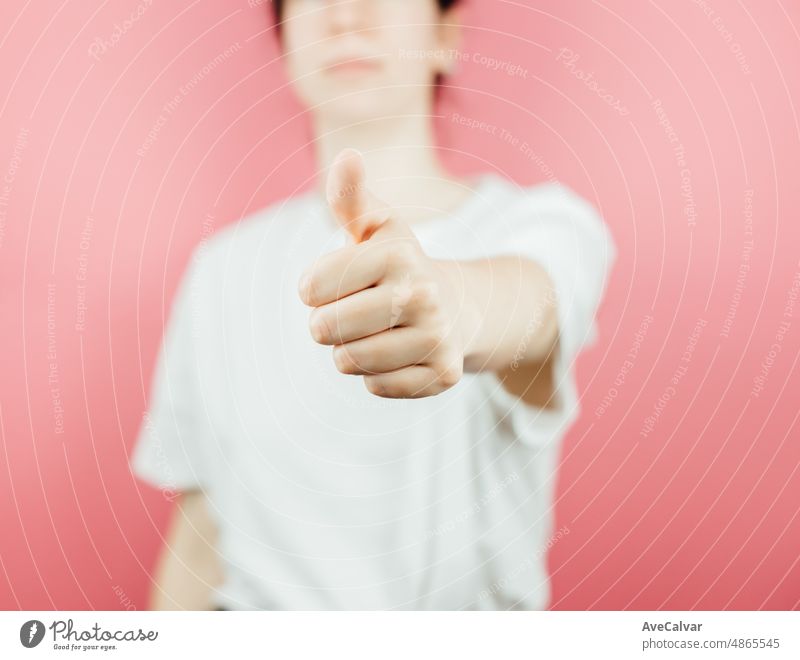 Woman doing the ok all good sign to camera over a pink background, help and self help concept, mental health. Good new concept, be happy. expression gesture