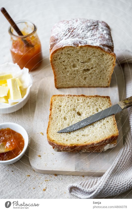 Crispy bread with butter and apricot jam on a linen tablecloth Breakfast Apricot Jam Bread cute Eating Fresh baked Linen Plate Knives Still Life Morning Butter