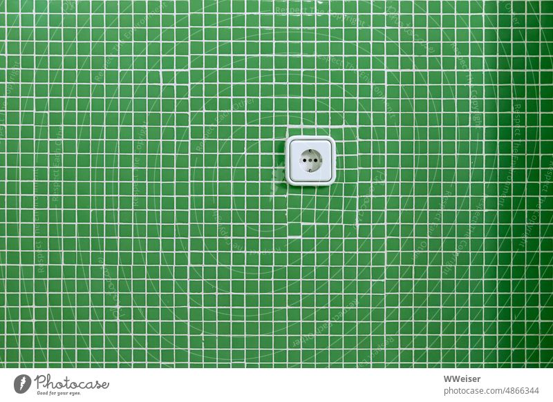 A socket in a green tile wall: green electricity? Socket tiles stream Energy Green Small Source Offer available To plunge Connector Cone obtain Wall (building)