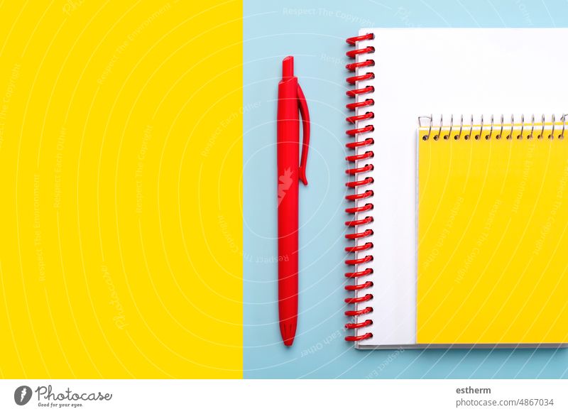 Top view of spiral notepad and red pen with space for text. Back to school concept education stationery back to school concept students notebooks colors pencils