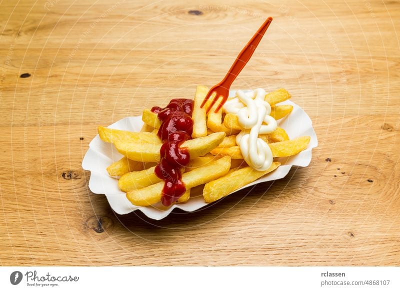 shell of french fries with ketchup and mayonnaise frit portion potato Pommes Dutch snack German potato rod fries stande fritüre thick eat chips french bude