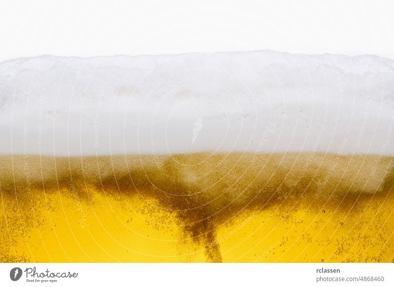 Pouring beer with bubble froth in glass for background isolated on white background pour alcohol brewery wave fresh liquid closeup pub copy space golden bottle