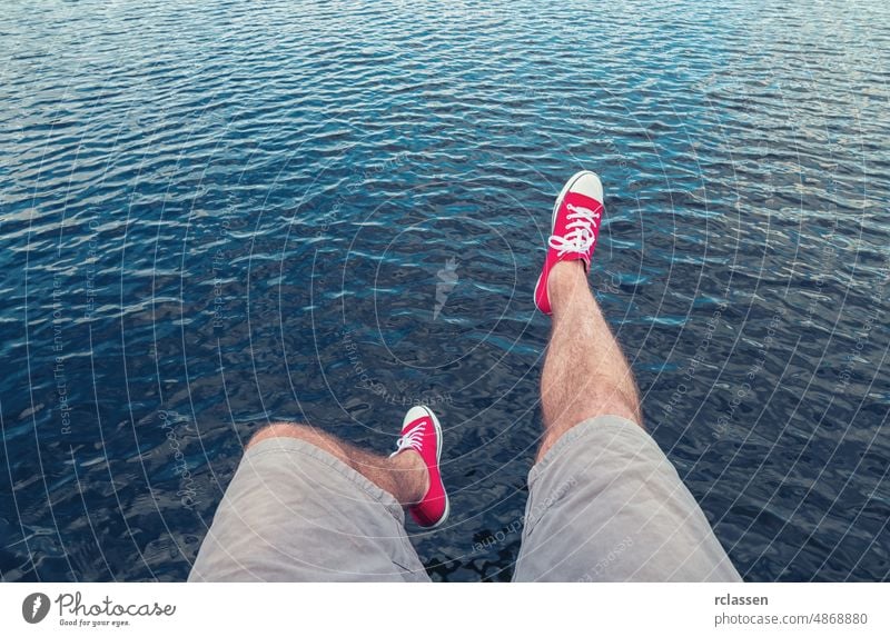 Young man in red sneakers jumps in to the ocean, Point of view shot pov people lifestyle point summer way caucasian close-up young first person view