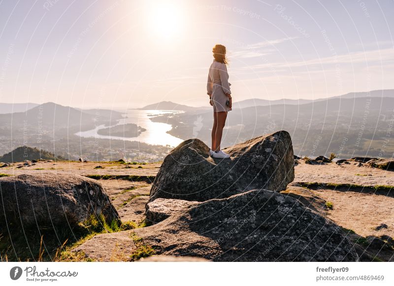 Young woman contemplating the landscape river copy space contemplation hiking hike relax wellness sunset alone nature solitude stone viewpoint seascape islands
