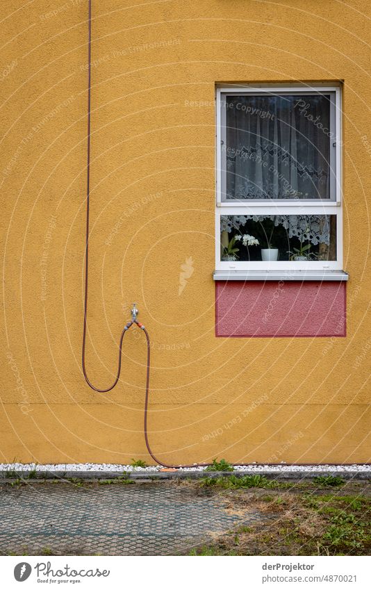 Wall with window and water hose Exterior shot Gloomy real estate Multicoloured Copy Space left Copy Space bottom Real estate market house purchase Tourism