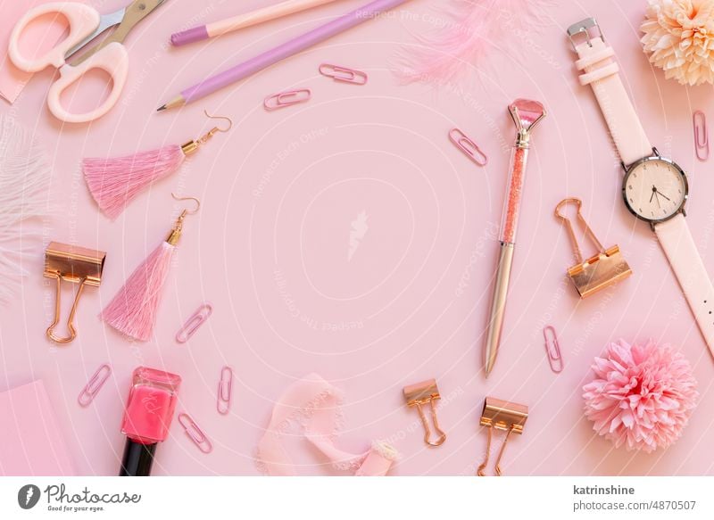 Pink school girly accessories and stationery on pastel pink Top view education nail polish scissors pencils paperclips Back to school workplace desk tools