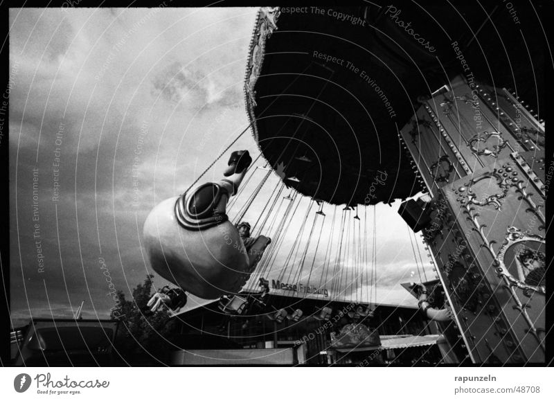 centrifugal Carousel Theme-park rides Fairs & Carnivals Chairoplane Child Contrast Black & white photo Rotate Detail Section of image Partially visible Swing