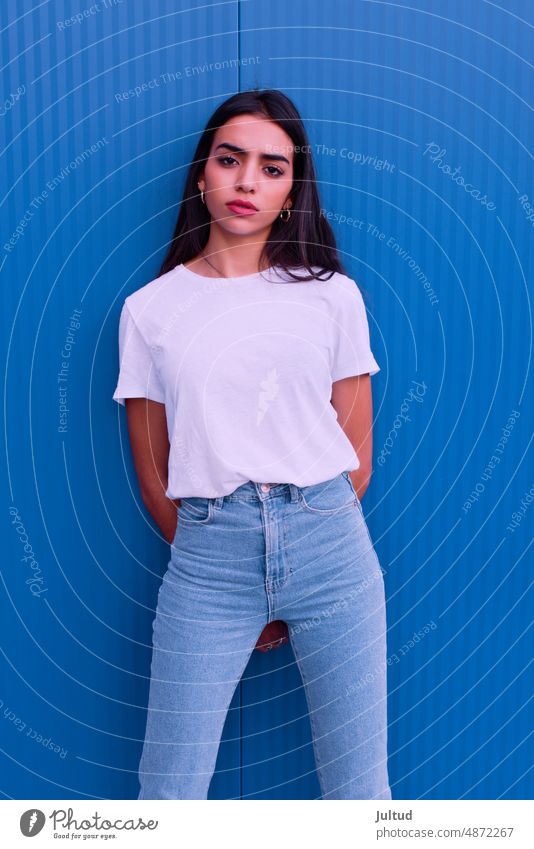 Portrait of young Arab woman in front of a blue wall Girl Ethnicity spain Young Woman Twenties Trendy BuildingExterior Young Female Young Adults alone One