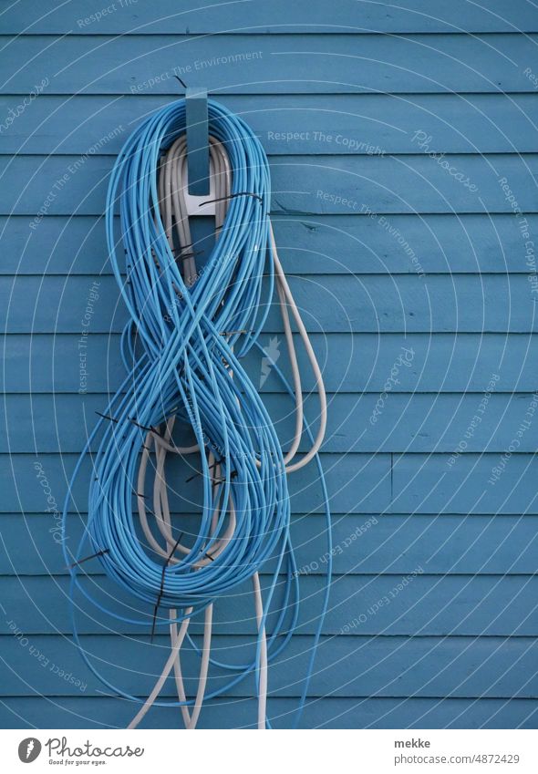 A blue eight is hiding - or are there more? number Eight 8 Blue power cable Cable Electricity Energy stream Energy industry Energy crisis Save energy