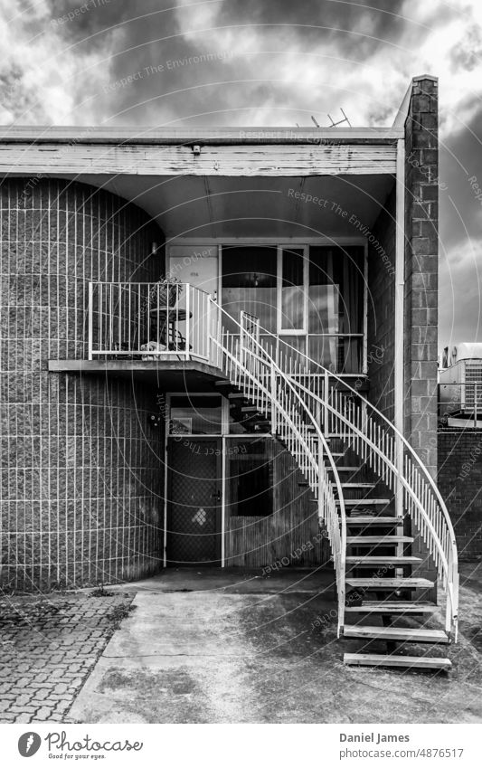Stairway sweeps up to modernist apartment Stairs Building Architecture Black & white photo Modernism House (Residential Structure) Wall (building)