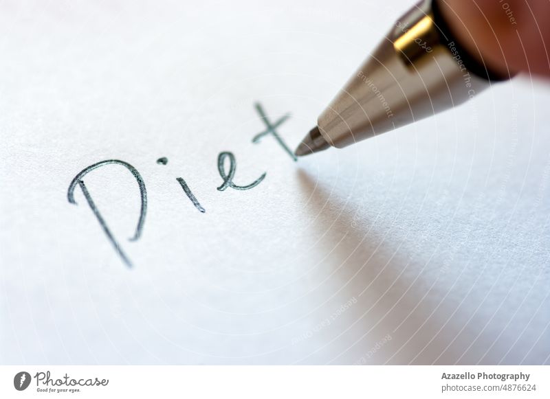 Close up image of writing a word DIET on a notebook paper. diet concept nutrition healthcare macro close up text handwritten plan success fitness vegetarian