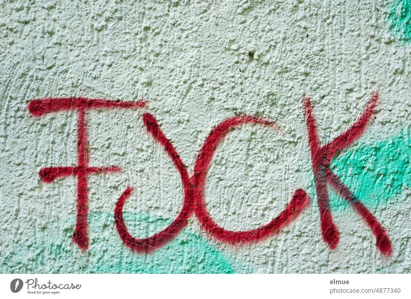 FUCK is written in red on a plastered wall / anger fuck Anger Graffiti Cuss word English negative mood Colour Red house wall Facade youth language Daub