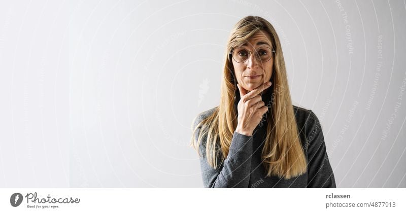 portrait of a mature woman with glasses looks Thoughtful, with copyspace for your individual text. think business businesswoman thoughtful teacher person young
