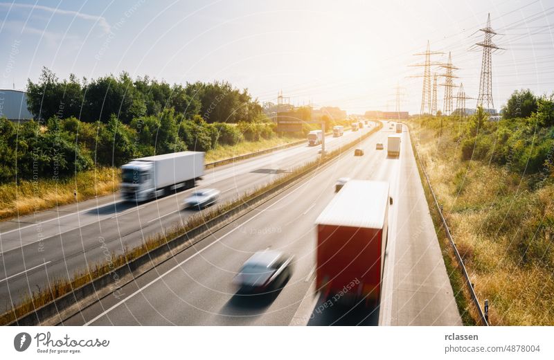 Lots of Trucks and cars on a Highway - transportation concept truck highway crowded freight automobile trailer delivery asphalt automotive blue blur business