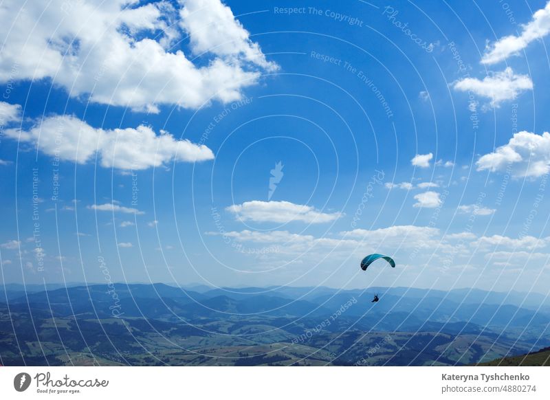 paragliding in the mountains action activity adrenalin adventure air background backgrounds blue brave cliff clouds courage extreme flight fly free freedom fun