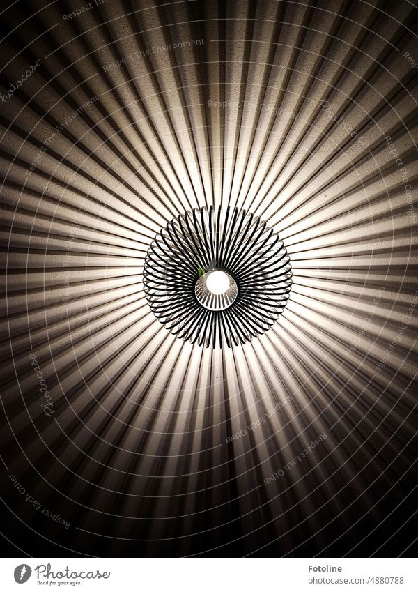 The ceiling lamp made of curved metal paints a crazy pattern on the ceiling of the room. Lamp Light Design Lighting Electric bulb Illuminate Visual spectacle