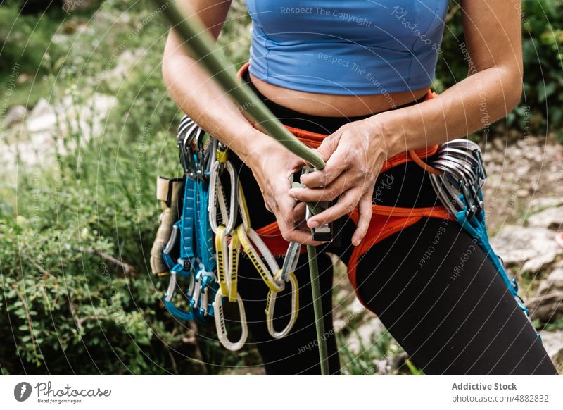 Midsection Of Woman Tying Rope On Harness Hiker Rappel Standing Climber Prepare Sport Hiking Holding Mountaineering Carefree Adventure Activity Carabiner