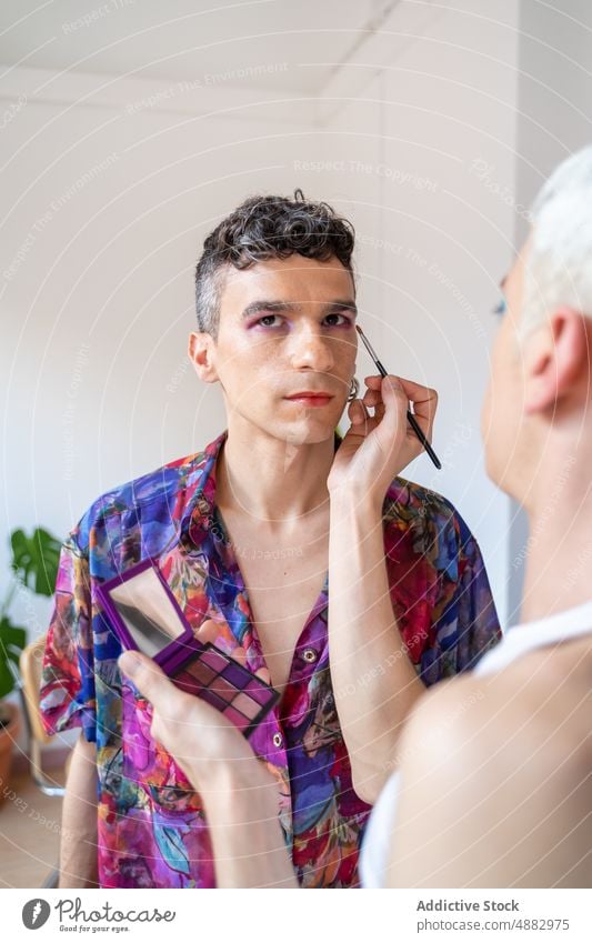 Transgender Man Getting Makeup Done By Boyfriend Couple Applying Eye Shadow Artist Cosmetic Gay Vanity Brush Together Palette Beautician Looking Away Beauty
