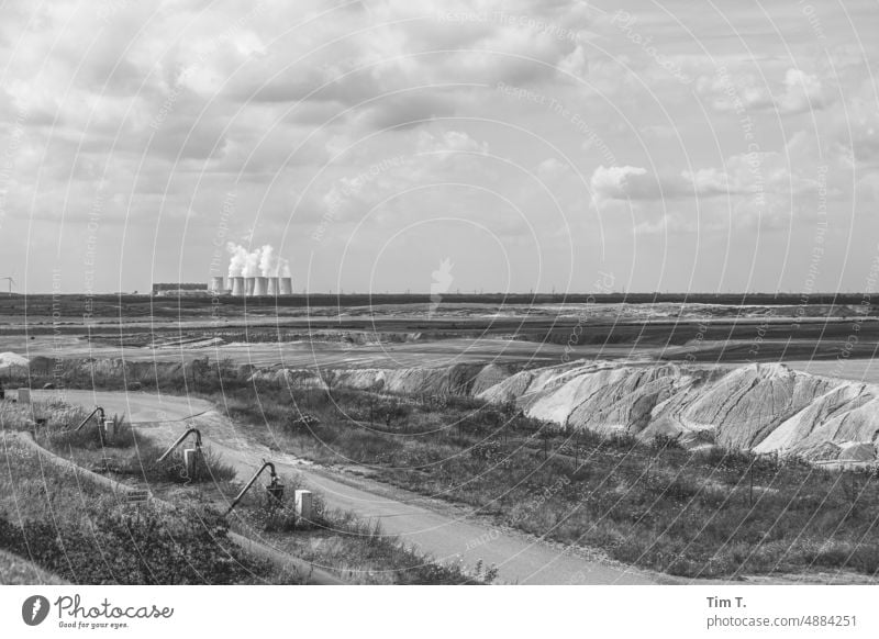 Opencast mining landscape with coal-fired power plant in the background Lausitz forest Coal power station Energy industry Sky Clouds Environmental pollution