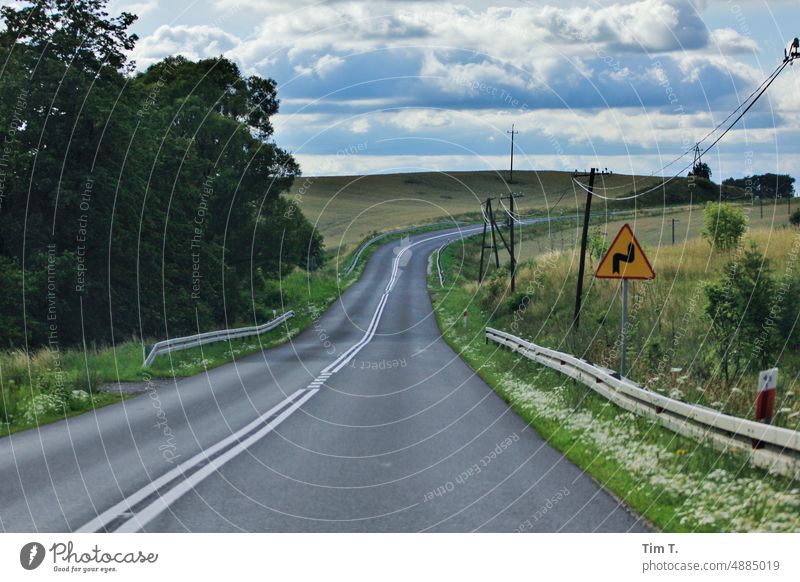 a curve on a country road in Poland Road sign Curve Colour photo Country road Summer Sky Street Transport Deserted Traffic infrastructure Exterior shot Nature