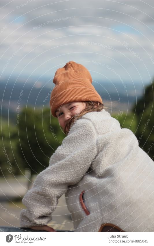winked at Girl pretty Outdoors Laughter Freckles Summer Autumn Sweater Jacket Cap Rhön Nature reserve Child be out Landscape Human being Vantage point