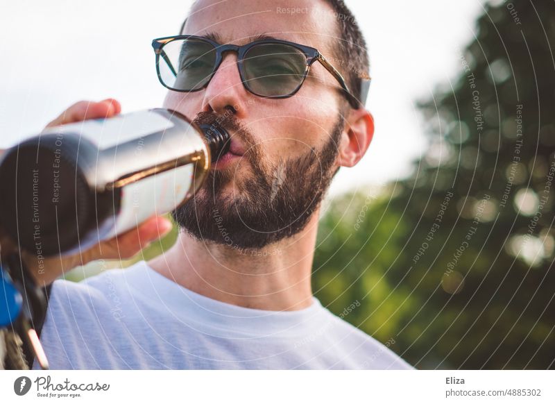 Man drinking a beer from the bottle Beer Drinking Bottle have a beer Alcoholic drinks Beverage Bottle of beer Thirst Eyeglasses Facial hair youthful Summer