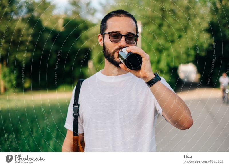 Man in t-shirt drinking beer from bottle outside Beer Drinking Bottle have a beer Alcoholic drinks Beverage Bottle of beer Thirst Eyeglasses Facial hair