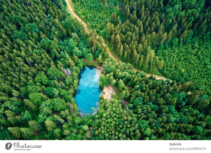 Aerial view of blue colored forest lake in Poland blue lake aerial green pond colorful poland above top water heart wild recreation mountain background