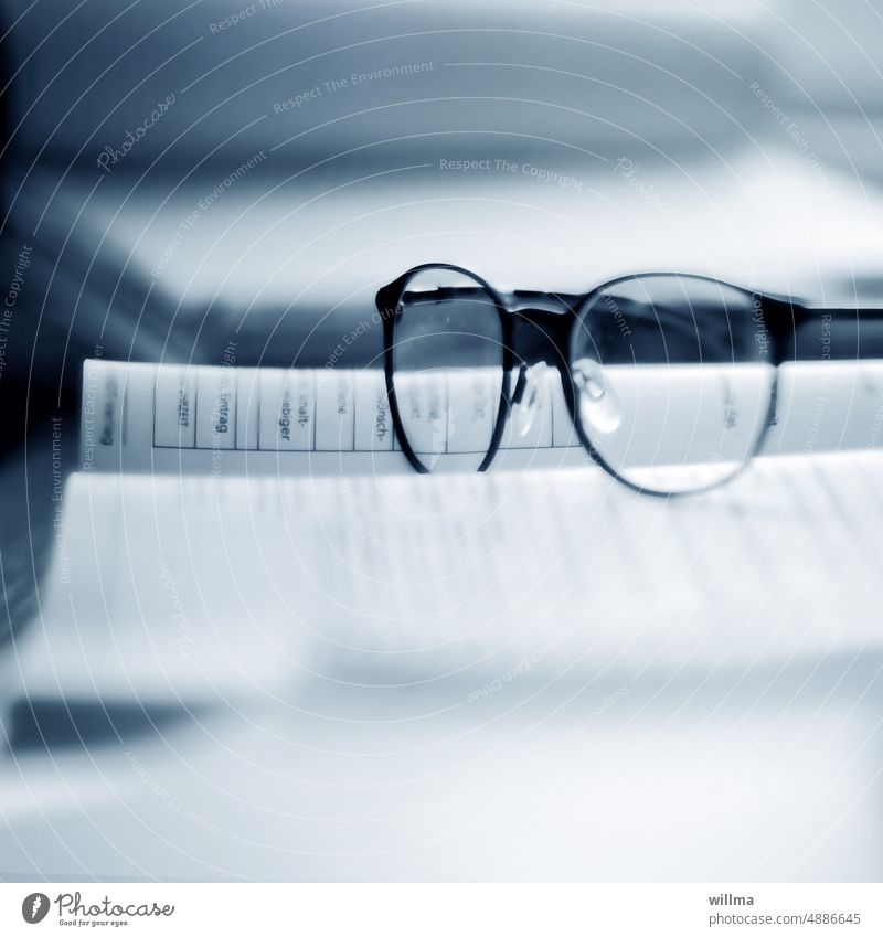 Man's spectacles are his (cleaning) kingdom Eyeglasses Book visually impaired visual aid Study study tax return Education School Academic studies Information