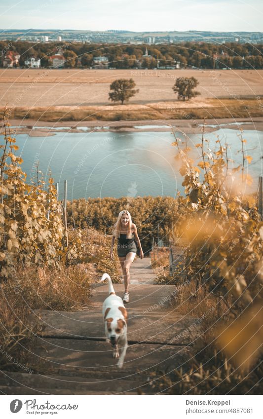 Woman relaxing while walking with dog on vineyard slope Face of a woman Woman's leg Girl power Idyll relaxed tranquillity relaxation Relaxation Summer free time