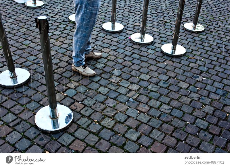 Test Center Mandatory testing Quick test test station COVID Row Bollard paving Places off waiting time Snake Queue Wait Stand Feet Human being leg