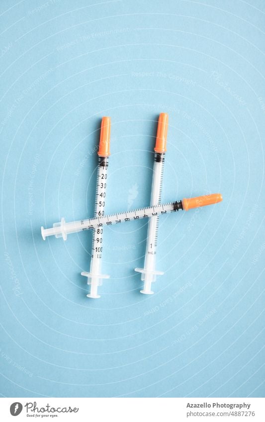 Medical syringes on blue background. Minimal medicine flat lay concept. business care clinic closeup corona coronavirus cough covid 19 cure disaster disease
