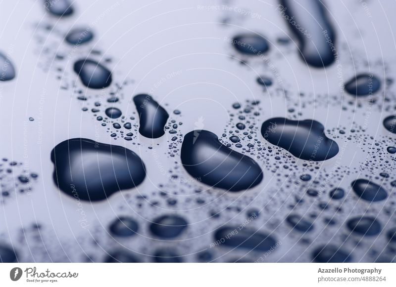 Close up image of water drops on a shiny surface in blue purple. abstract aqua art background black blur bubble clean clear close up condensation creative dark