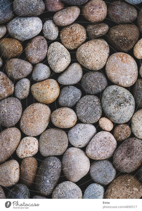 Natural pebbles texture, sea stones moody background, zen, summer, beach, full frame pebbles background vertical shot brown gray natural rock pattern abstract