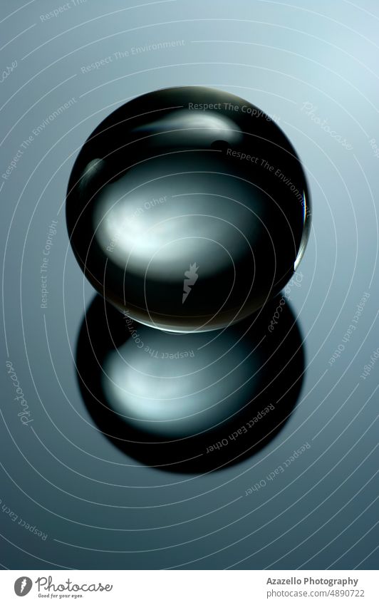Abstract still life image of a glass ball in a low key. Geometric object with reflection, Glass sphere in a low key. minimalism abstract magic surrealism